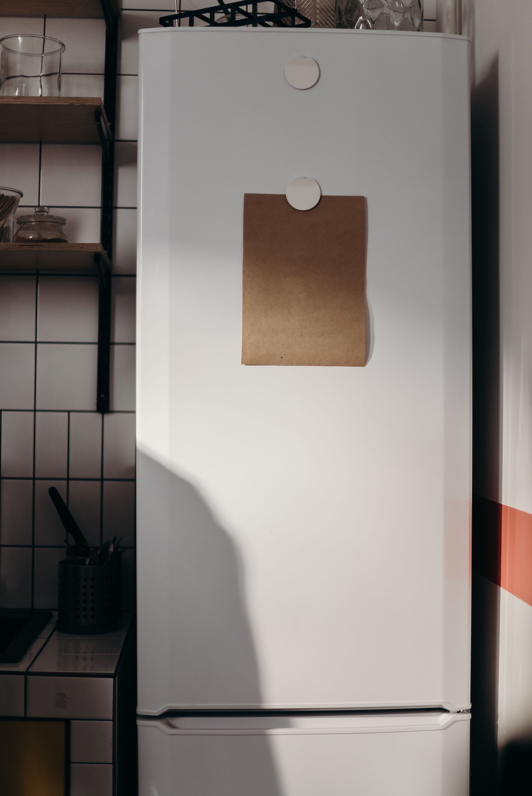 Cozy kitchen with a blank paper on the fridge, ideal for mockups or notes.